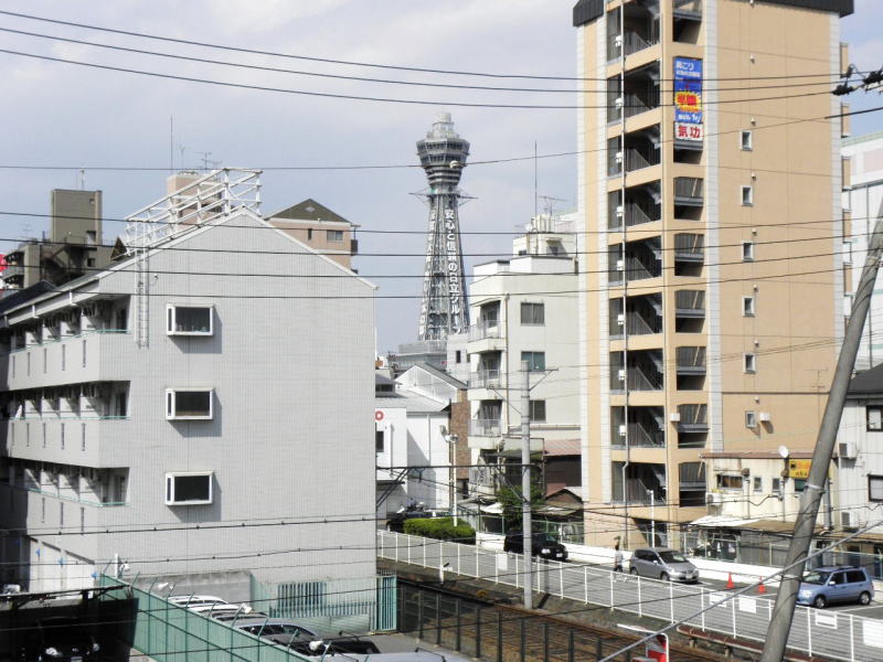 通天閣と、ビルの谷間の阪堺電車の線路